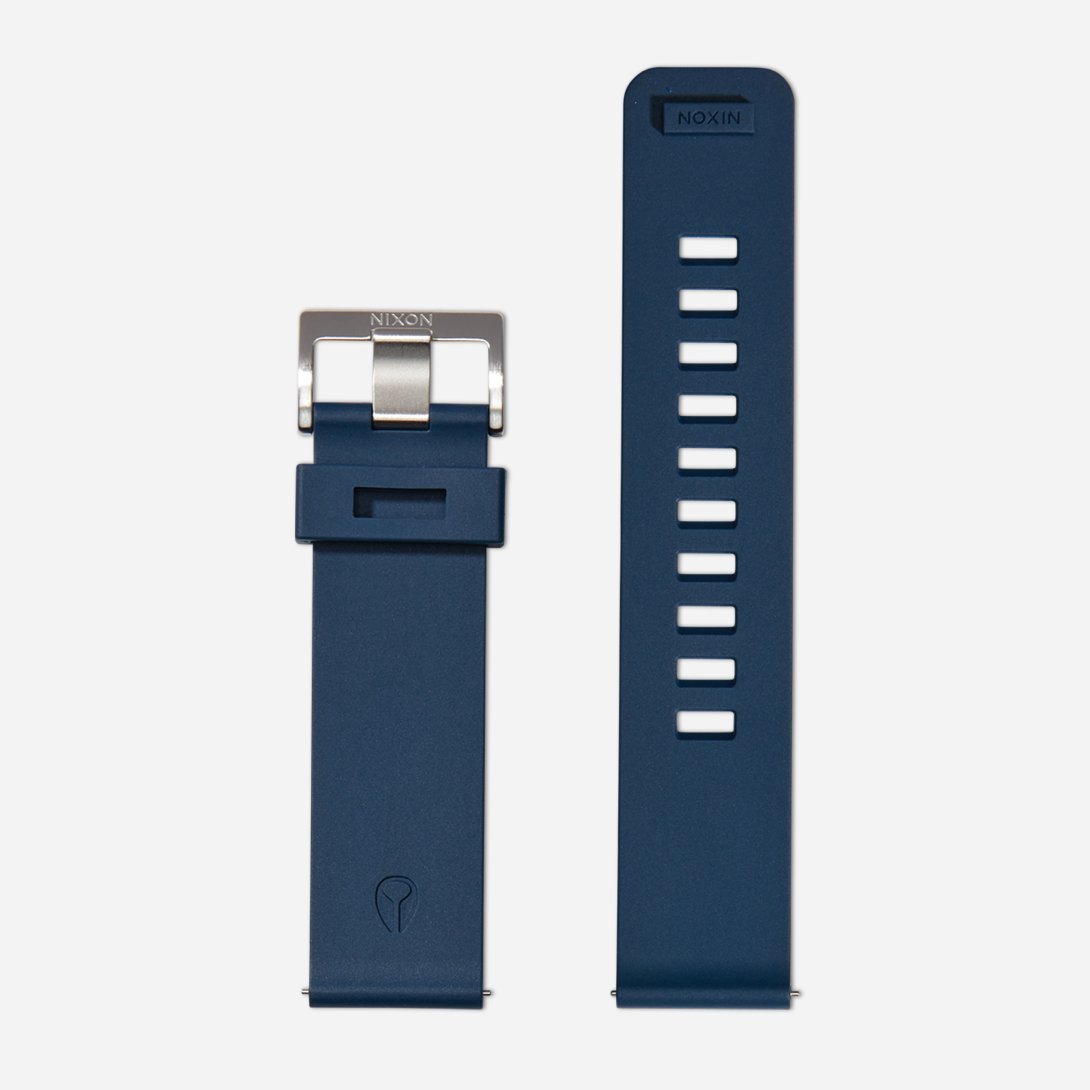 A dark blue rubber Nixon watch band.